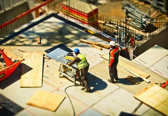 Two workers maintaining a commercial property with scaffolding, highlighting professional property maintenance services in Thousand Palms, CA.