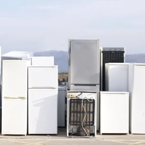 Three large white refrigerators ready for removal, showcasing large item junk removal services in Desert Hot Springs, CA.